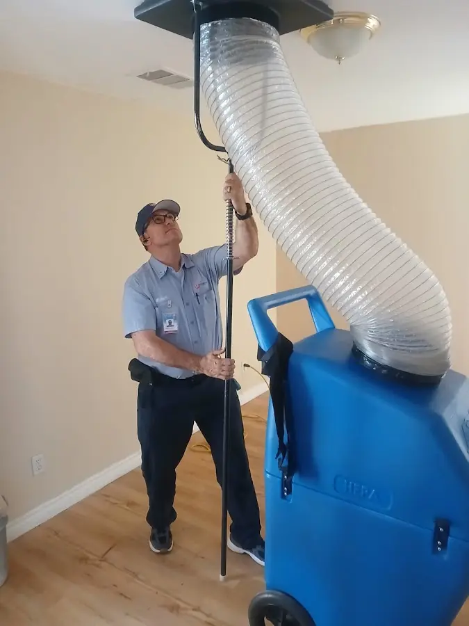 Furnace Tune-Up technician using HEPA equipment in Merritt Island